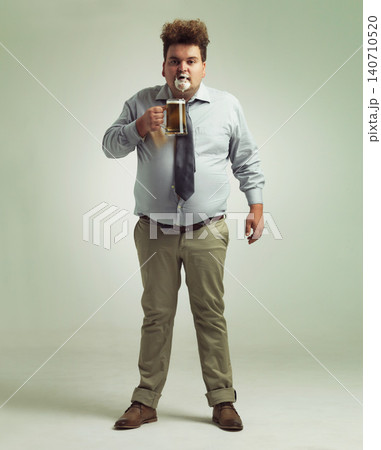 Man, portrait and face with beer foam, drink or party in obesity on a studio background. Male person or plus size model with glass, mug or alcohol in satisfaction for wine or booze on mockup space 140710520