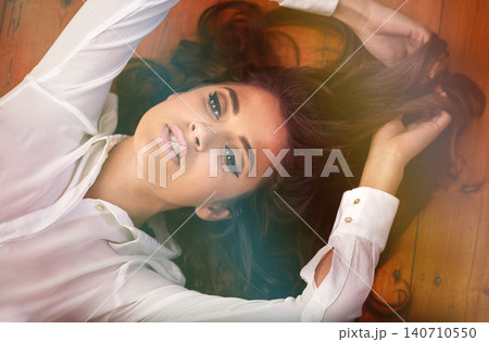 Beauty, woman or cosmetics on floor for facial glow, above or foundation for make up. Model, cosmetology and eyeliner or mascara on wooden background, brunette and haircare or conditioner in closeup Beauty, woman or cosmetics on floor for facial glow, above or foundation for make up. Model, cosmetology and eyeliner or mascara on wooden background, brunette and haircare or conditioner in closeup 140710550
