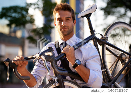 Portrait, cycling and business man for commute, transportation and carbon neutral in city. Professional, sustainable and face of male employee walking with bicycle for travel, journey or eco friendly 140710597