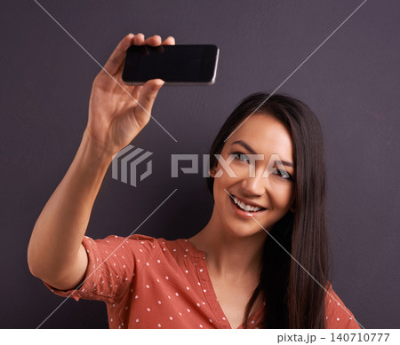Woman, selfie and social media post for online connection on studio for profile picture, technology or grey background. Female person, smile and internet communication or streaming, vlog or mockup Woman, selfie and social media post for online connection on studio for profile picture, technology or grey background. Female person, smile and internet communication or streaming, vlog or mockup 140710777