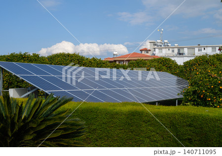 Solar panels harnessing sunlight in a vibrant coastal neighborhood during a clear day Solar panels harnessing sunlight in a vibrant coastal neighborhood during a clear day 140711095