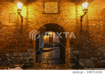 Medieval Archway Passage in Old Town Riga Lit by Warm Lanterns at Night, Latvia Medieval Archway Passage in Old Town Riga Lit by Warm Lanterns at Night, Latvia 140711282