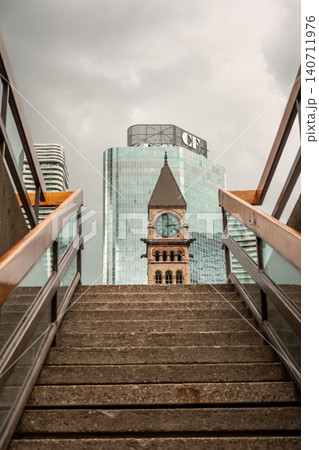 Old City Hall Toronto Clock Tower Framed by Staircase with Modern Skyline Contrast Old City Hall Toronto Clock Tower Framed by Staircase with Modern Skyline Contrast 140711976