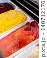 Ice cream trays. Frozen dessert. Bright color cold treat set with different flavor in freezer. Sweets with strawberry garnish in shop. 140712176