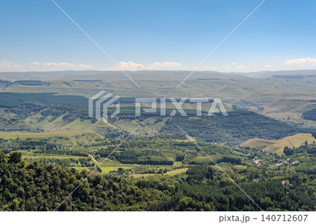 Panoramic view of the green valley and the snowy peak of Mount Elbrus on the horizon against the blue sky on a sunny clear morning in Kislovodsk Stavropol territory, Russia Panoramic view of the green valley and the snowy peak of Mount Elbrus on the horizon against the blue sky on a sunny clear morning in Kislovodsk Stavropol territory, Russia 140712607