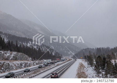 Interstate 70 Colorado Rocky Mountains Highway in Winter Snowfall with Traffic Through Mountain Interstate 70 Colorado Rocky Mountains Highway in Winter Snowfall with Traffic Through Mountain 140712790