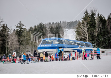 Snowshoe West Virginia Ski Resort with Chairlift Loading Area Skiers Snow Covered Slopes Snowshoe West Virginia Ski Resort with Chairlift Loading Area Skiers Snow Covered Slopes 140712813