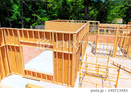 Workers are beams framing new house in residential structure is taking shape. 140713483