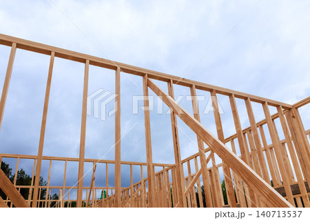 Workers build wooden beams frame for new structure as overhead in an outdoor area. Workers build wooden beams frame for new structure as overhead in an outdoor area. 140713537