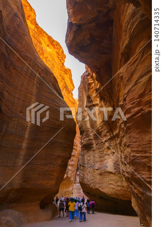 Petra, Wadi Musa, Jordan - Mar 06 2023, Siq Gorge, a narrow winding passage in canyon, vertically, Petra, Wadi Musa, Jordan Petra, Wadi Musa, Jordan - Mar 06 2023, Siq Gorge, a narrow winding passage in canyon, vertically, Petra, Wadi Musa, Jordan 140714335