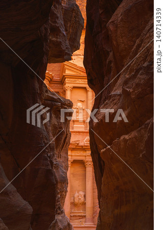 Petra, Wadi Musa, Jordan - Mar 06 2023, view of Al-Khazneh tomb from Siq Gorge, symbol of the city of Petra, Wadi Musa, Jordan 140714339