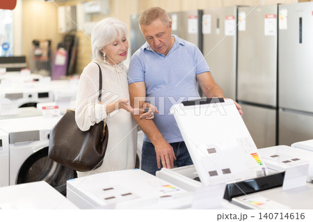 Elderly couple choosing a washing machine in a store 140714616