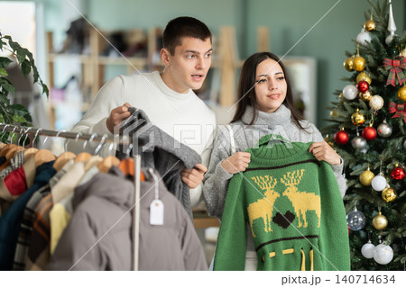 Couple customer choose sweater variation, New Year atmosphere Couple customer choose sweater variation, New Year atmosphere 140714634