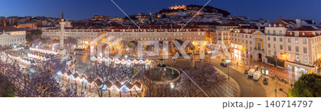 Panoramic blue hour view of Rossio Square with illuminated buildings and the hilltop fortress overlooking central Lisbon. Panoramic blue hour view of Rossio Square with illuminated buildings and the hilltop fortress overlooking central Lisbon. 140714797