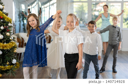 Children rehearsing ballroom dance for upcoming Christmas party at school 140714928