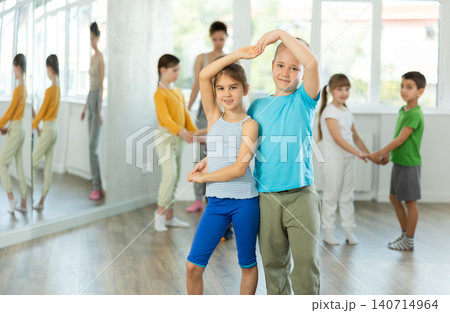 Preteen children learning to dance waltz in pairs in choreography class Preteen children learning to dance waltz in pairs in choreography class 140714964
