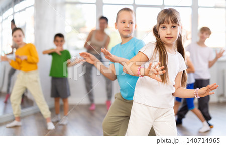 Girl paired up with boy and training to perform boogie woogie couple dance, rehearse performance. Girl paired up with boy and training to perform boogie woogie couple dance, rehearse performance. 140714965