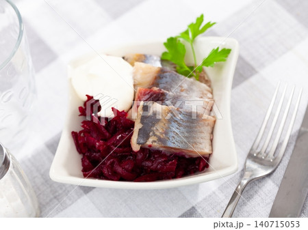 Pickled herring slices with grated beets, mayonnaise and fresh parsley Pickled herring slices with grated beets, mayonnaise and fresh parsley 140715053