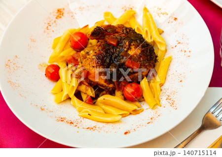 Chicken thigh baked with vegetables and herbs with pasta garnish 140715114