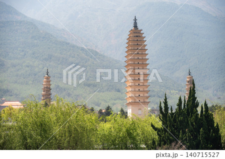 An iconic Three Pagodas in Dali old town, China. This is the cultural symbol of Dali. Located at the foot of Cangshan Mountain.  140715527