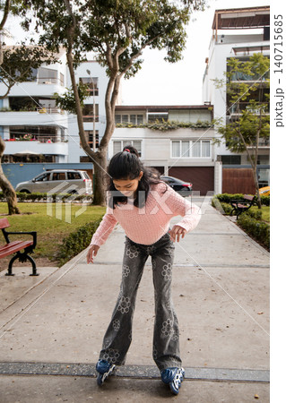 Young Girl Standing on Rollerblades in Park Path Young Girl Standing on Rollerblades in Park Path 140715685