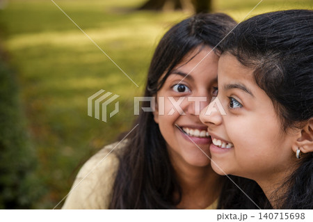 Portrait of Two Happy Sisters Smiling Together in Park Portrait of Two Happy Sisters Smiling Together in Park 140715698