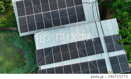 Solar power system installed on farm rooftop with high efficiency photovoltaic panels. Renewable electricity, carbon reduction, rural energy solutions and sustainable development in Thailand. 140715773