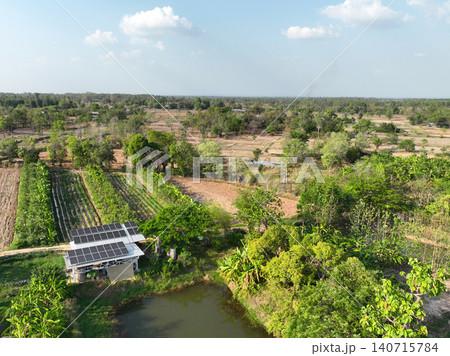 Drone view of rural farmland featuring photovoltaic solar power system, irrigation infrastructure and productive agricultural land in a sustainable environment. Renewable energy. Modern farming. Drone view of rural farmland featuring photovoltaic solar power system, irrigation infrastructure and productive agricultural land in a sustainable environment. Renewable energy. Modern farming. 140715784