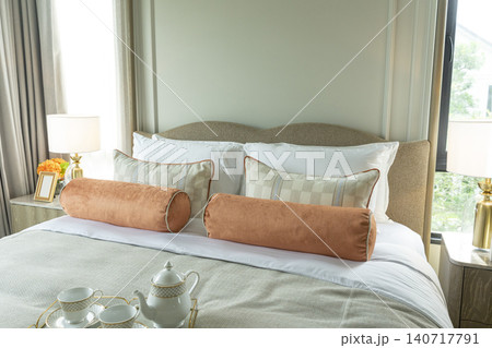 King Size Canopy Bed Frame with pillows in elegant bedroom interior. Honeymoon suite bedroom in pastel and pink colors style bedroom in white room Boudoir. King Size Canopy Bed Frame with pillows in elegant bedroom interior. Honeymoon suite bedroom in pastel and pink colors style bedroom in white room Boudoir. 140717791