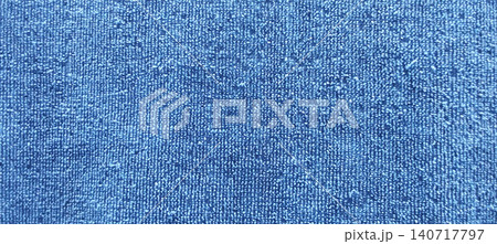 A close up of the blue fabric texture with a fine weave pattern showing the details of the fibers and the tight weave. 140717797