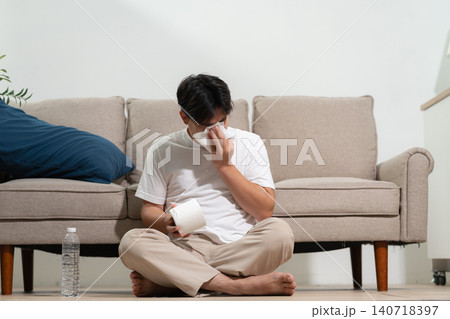 Asian young man feeling sick and headache, health care concept. Asian young man feeling sick and headache, health care concept. 140718397