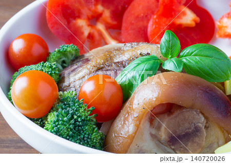 Baked HAM steaks lie on green lettuce leaves, cherry tomatoes, pineapple 140720026