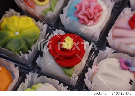 Colorful Flower-Decorated Pastries in Display Cases 140721479
