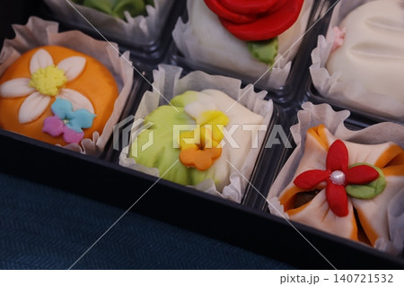 Colorful Flower-Decorated Pastries in Tray Colorful Flower-Decorated Pastries in Tray 140721532
