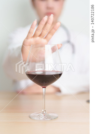 Doctor hand stop to refuse Wine, quitting drink for healthy liver, prevent Alcoholic cirrhosis and cancer, World No Alcohol Day, medical advice for sobriety and Alcoholism and addiction concept Doctor hand stop to refuse Wine, quitting drink for healthy liver, prevent Alcoholic cirrhosis and cancer, World No Alcohol Day, medical advice for sobriety and Alcoholism and addiction concept 140722186