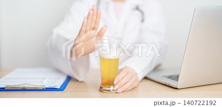 Doctor hand stop to refuse Beer, quitting drink for healthy liver, prevent Alcoholic cirrhosis and cancer, World No Alcohol Day, medical advice for sobriety and Alcoholism and addiction concept 140722192
