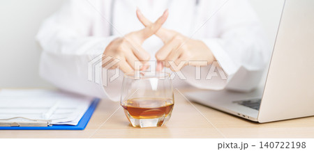 Doctor hand stop to refuse Whisky, quitting drink for healthy liver, prevent Alcoholic cirrhosis and cancer, World No Alcohol Day, medical advice for sobriety and Alcoholism and addiction concept Doctor hand stop to refuse Whisky, quitting drink for healthy liver, prevent Alcoholic cirrhosis and cancer, World No Alcohol Day, medical advice for sobriety and Alcoholism and addiction concept 140722198