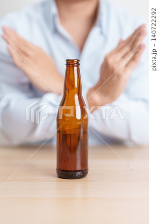 man making stop hand gesture to refuse a bottle of Beer, Healthy man say no to alcohol drink, stop alcoholism and addiction concept. Responsible man reject a drink before driving and quit booze 140722292