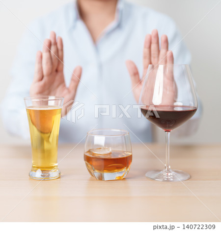man stop hand gesture to refuse a glass of wine, beer, whiskey or cognac on table. say no to alcohol drink, stop alcoholism addiction, Responsibility, reject a drink before drive and quit booze man stop hand gesture to refuse a glass of wine, beer, whiskey or cognac on table. say no to alcohol drink, stop alcoholism addiction, Responsibility, reject a drink before drive and quit booze 140722309