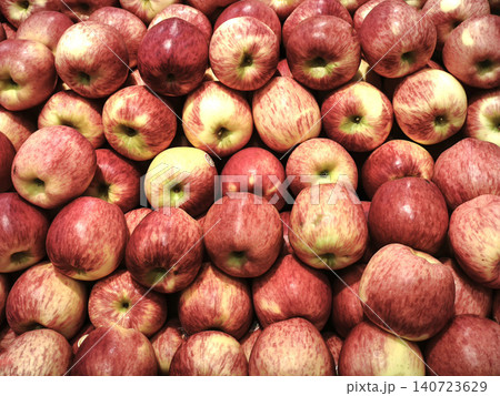 Full frame background of fresh organic red apples piled on display at a supermarket or grocery store produce section. Full frame background of fresh organic red apples piled on display at a supermarket or grocery store produce section. 140723629