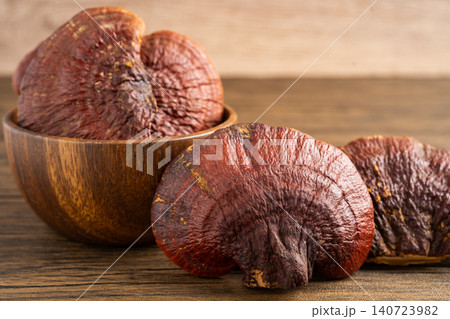Dried lingzhi mushroom with capsule drug, alternative medicine herbal organic herb. Dried lingzhi mushroom with capsule drug, alternative medicine herbal organic herb. 140723982