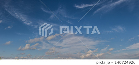Vibrant blue sky with fluffy white clouds during late afternoon at a rural location Vibrant blue sky with fluffy white clouds during late afternoon at a rural location 140724926