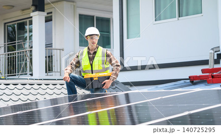 Solar Panel Technician Installing Photovoltaic Panels on Residential Rooftop with Toolbox Solar Panel Technician Installing Photovoltaic Panels on Residential Rooftop with Toolbox 140725295