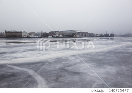 A wide frozen Neva river and icy waterfront. Saint-Petersburg A wide frozen Neva river and icy waterfront. Saint-Petersburg 140725477