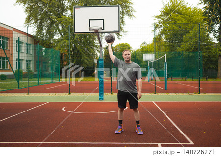 Full shot man holding basketball ball on court Full shot man holding basketball ball on court 140726271