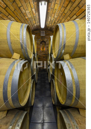 Wine barrels aging in traditional brick cellar Knezdub Czechia 140726365