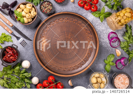 Empty rustic plate with fresh cooking ingredients 140726514