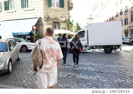 Rear view of male tourist walking down cobblestone street in Rome Rear view of male tourist walking down cobblestone street in Rome 140726535