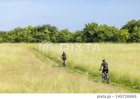 Women mountain biking on a path in nature 140726668