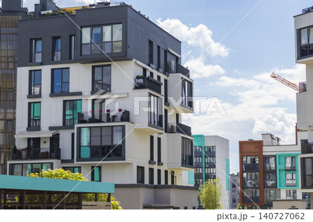 Modern apartment building facades with green and dark grey color blocks under sunny blue sky. Urban Modern apartment building facades with green and dark grey color blocks under sunny blue sky. Urban 140727062